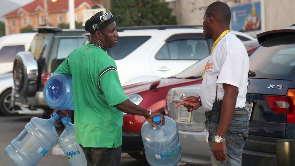 Man holding water bottles