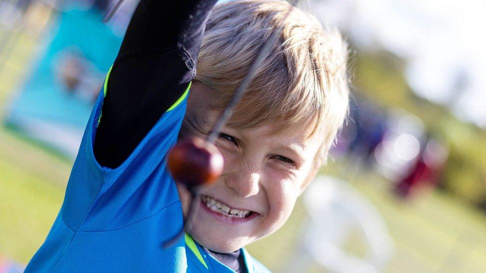 A child holding a conker