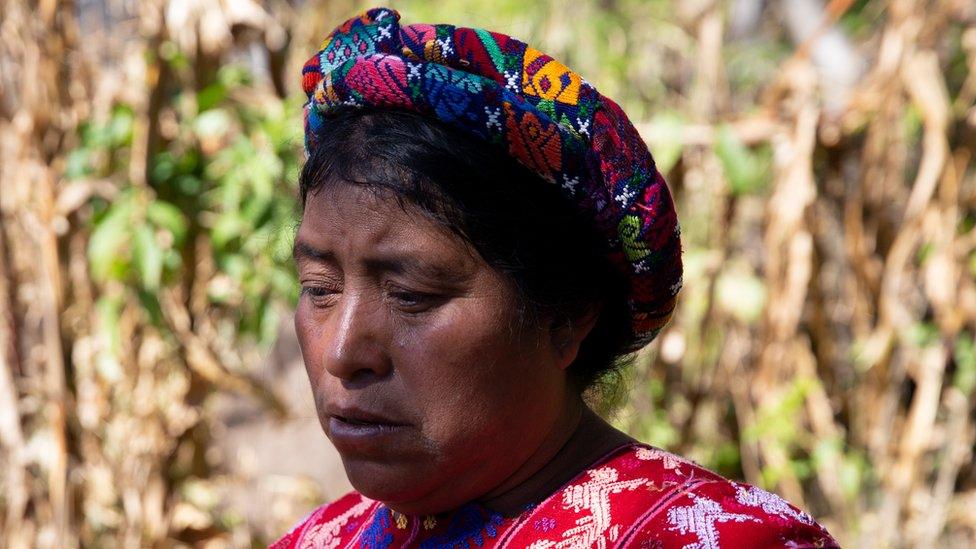 Maria de la Cruz Lopez Vasquez poses for a portrait in the cornfields in her hometown of Cajola, Guatemala.