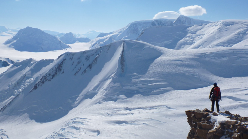 Explorer looking over snow scene