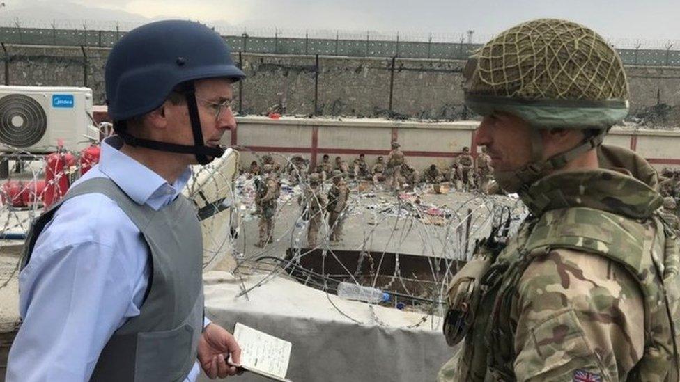 Laurie Bristow (left) speaking to a member of the UK armed forces at Kabul airport