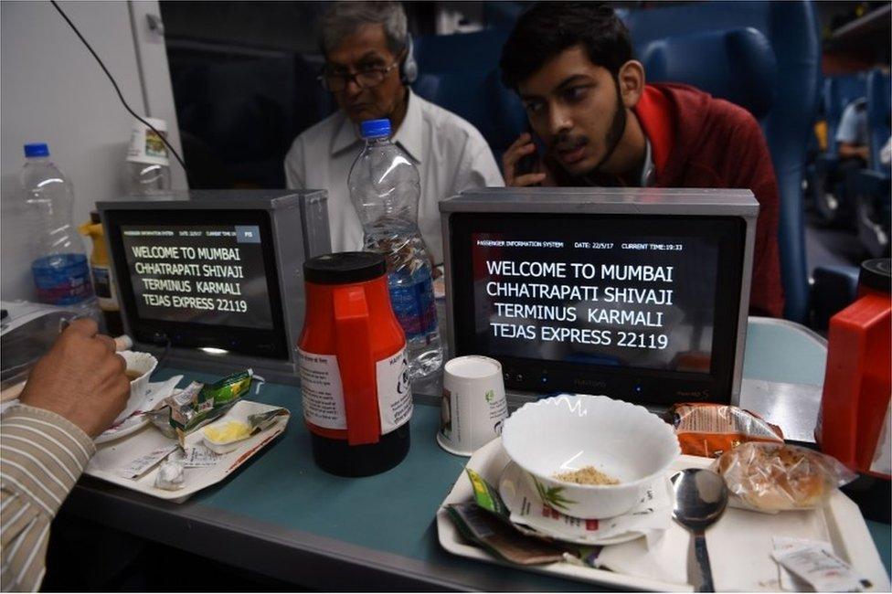 In this photograph taken on May 22, 2017, Indian passengers travel onboard the Tejas Express luxury train during its first journey between Mumbai and Goa in Mumbai.