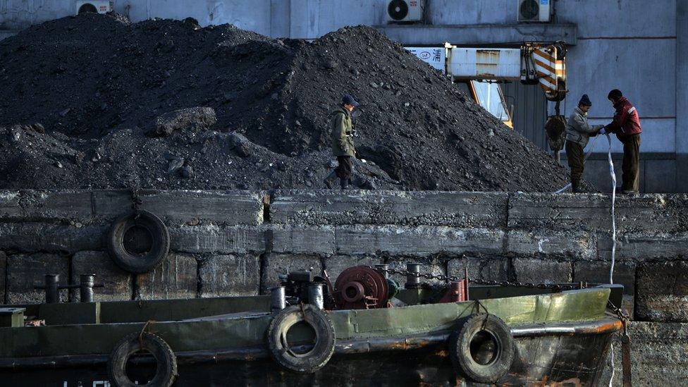 North Korean labourers work beside the Yalu River at the North Korean town of Sinuiju on 8 February 2013 which is close to the Chinese city of Dandong.