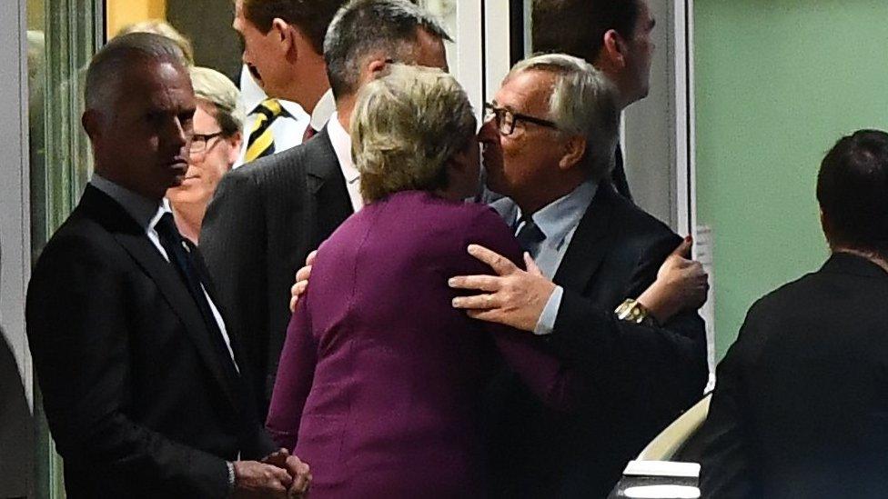 Mrs May and Mr Juncker embrace after the dinner in Brussels