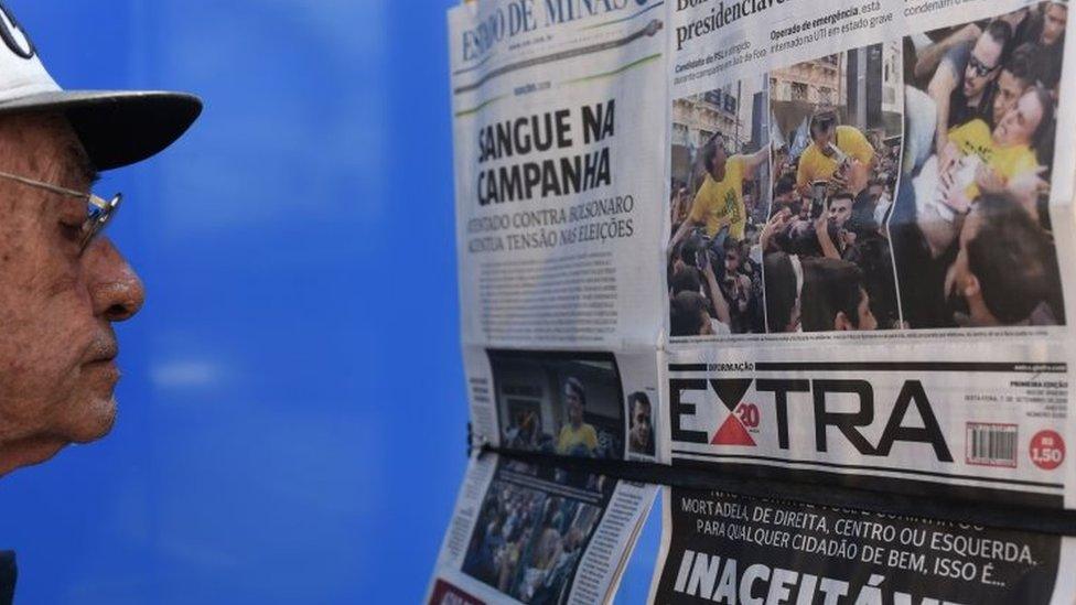 A man looks at the front pages of newspapers on the attack against Brazilian presidential candidate Jair Bolsonaro in Juiz de Fora,