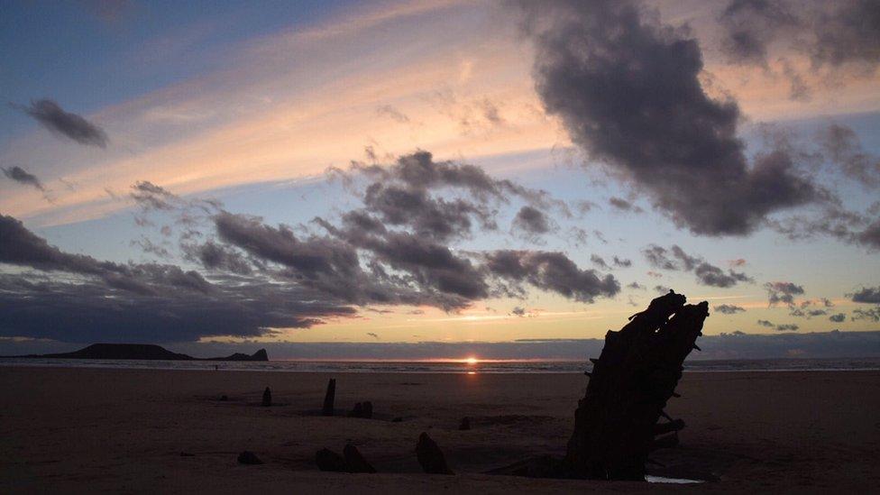 The sunset over Worms Head from Rhossili Bay