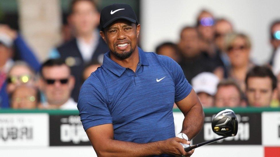 iger Woods of the United States reacts after playing a shot during the Dubai Desert Classic golf tournament at the Emirates Golf Club in Dubai.