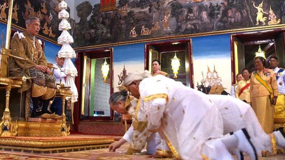 Chief Brahmin Phra Ratcha Khru Vamadeb Muni (front) honours King Maha Vajiralongkorn during the coronation