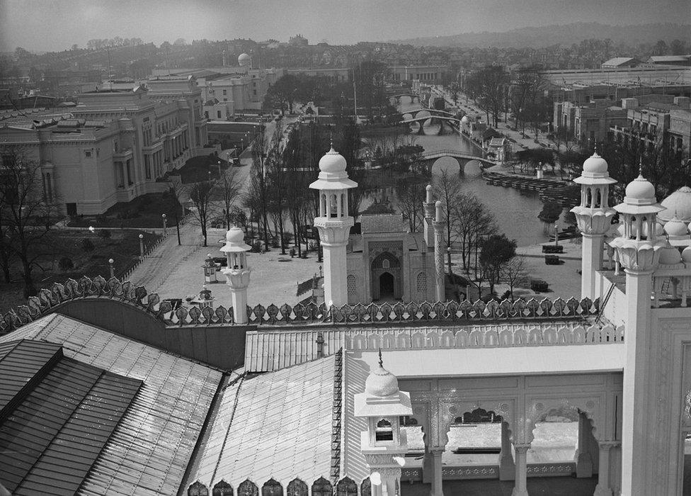 Black and white image showing bridges and river running through exhibition site as well as different pavilions