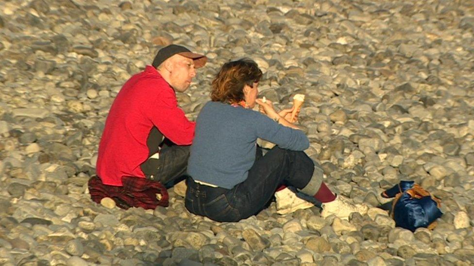 People eating ice cream in the sun in Penarth