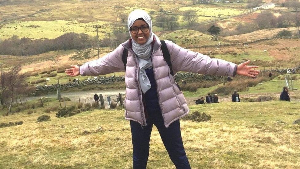 Fatima standing on a hill in the countryside