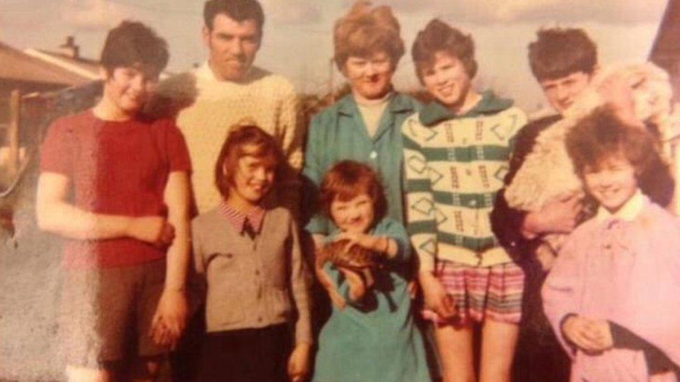 Kim Fenton as a child wearing her artificial leg. Pictured with her parents and her siblings.