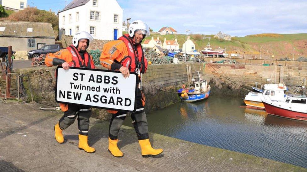 Lifeboat crew with sign