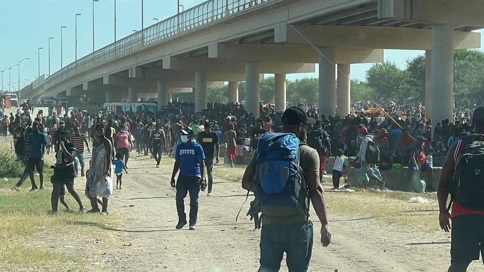 Migrants gather under the international bridge at Del Rio on 16 September 2021