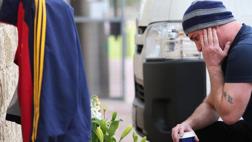 A fan reflects on the death of Adelaide Crows coach Phil Walsh at the club's headquarters in Adelaide, South Australia, 3 July, 2015