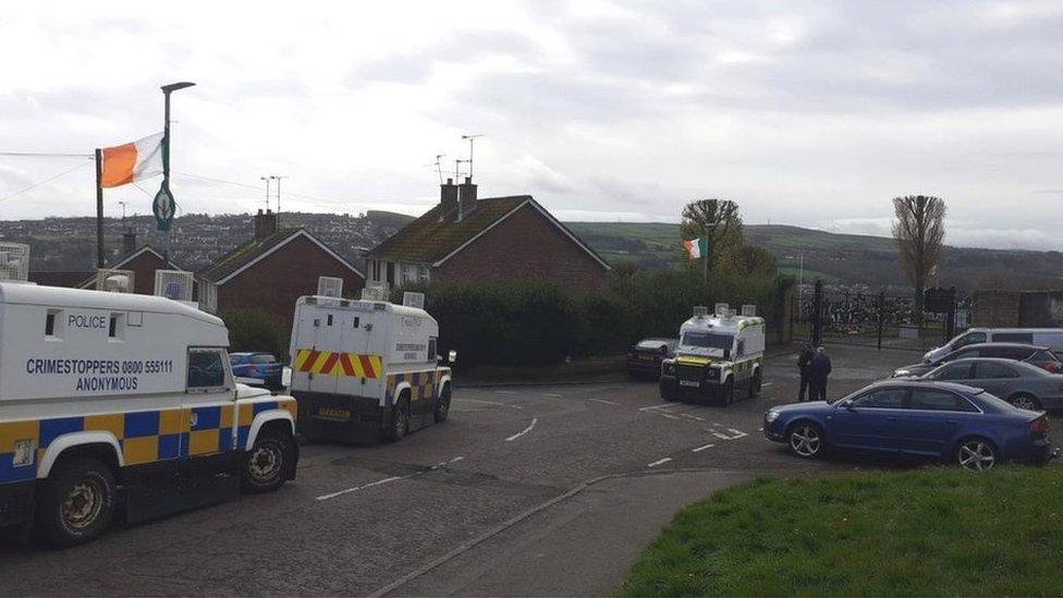 Police vans outside the gates of the Derry City Cemetery.