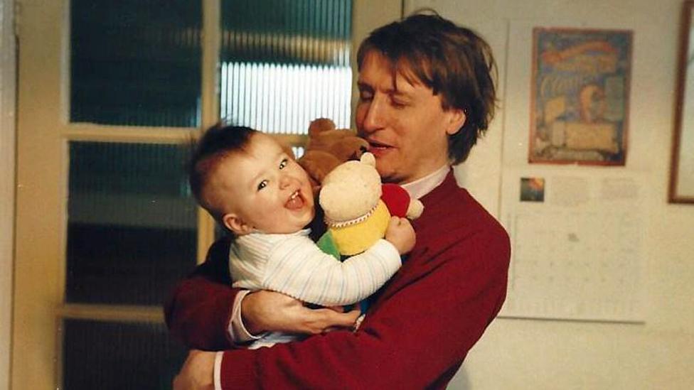 Mike holding baby Caitlin