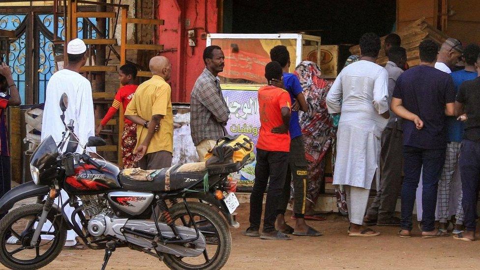 People queuing for bread outside a bakery in Khartoum