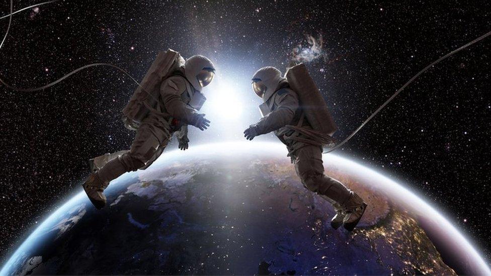 Two astronauts in space