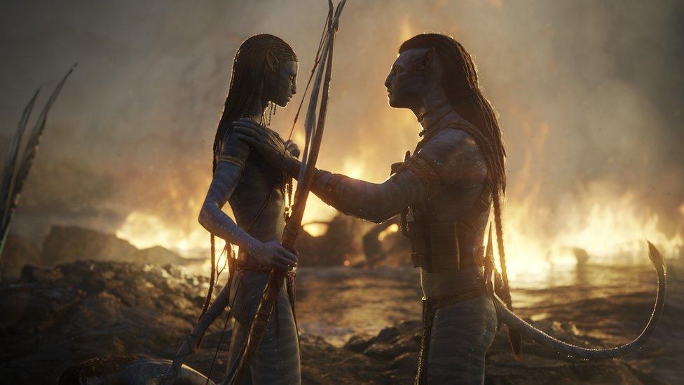 A still from Avatar: Way of the Water showing (left to right) Neytiri and Jake Sully