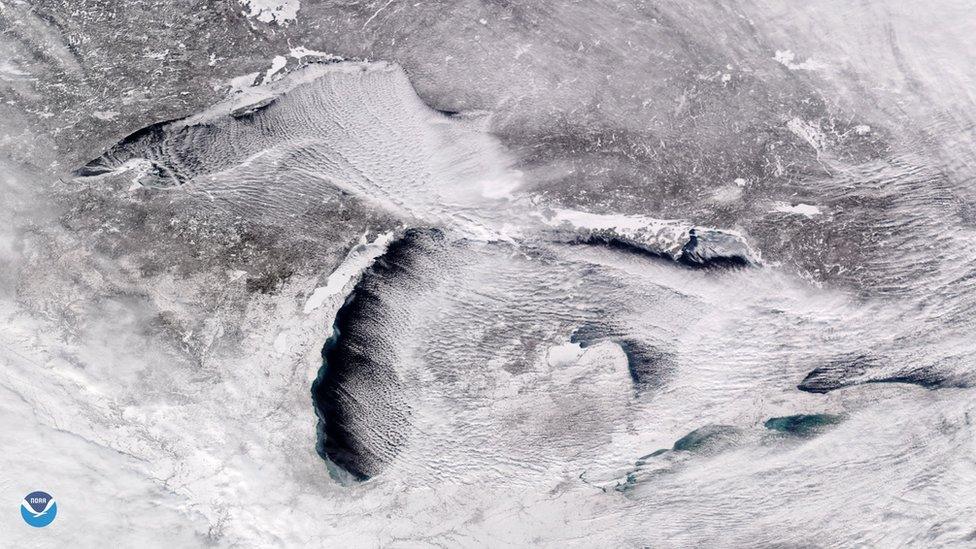 Satellite image from above the Great Lakes showing parallel rows of cumulus clouds also known as "cloud streets"