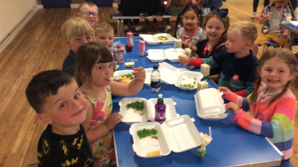 Kids eating fish and chips.