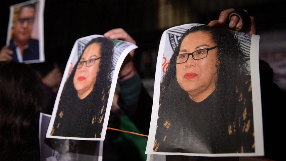 A man holds photos of journalist Lourdes Maldonado Lopez during a protest to demand justice, in front of the Interior Ministry Office, in Mexico City, Mexico on 25 January