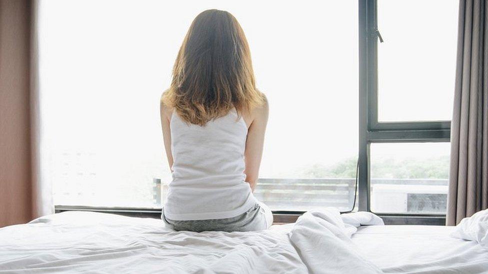 Stock image of a woman on a bed