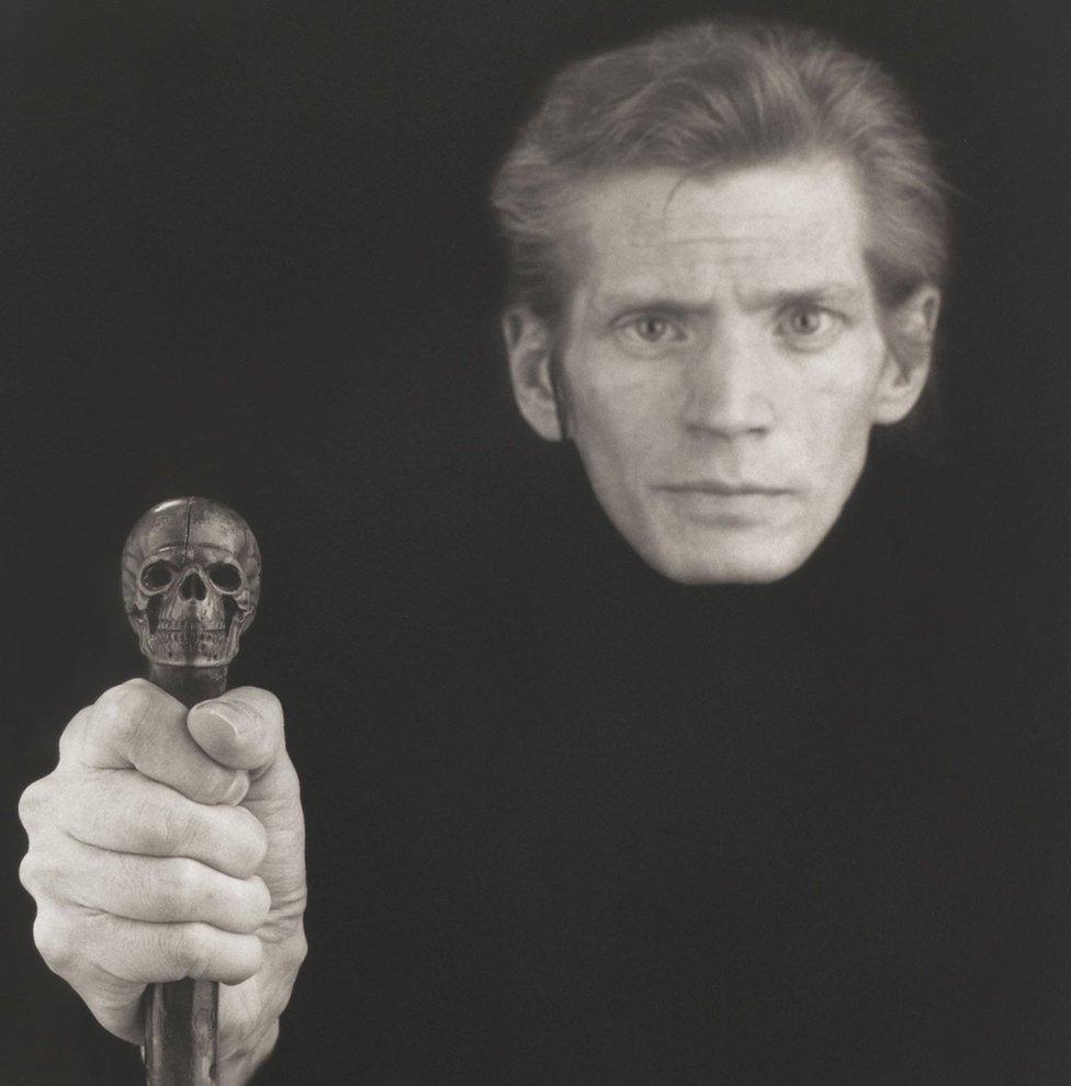 Robert Mapplethorpe self-portrait in 1989 shows him holding a skull cane in front of him - a reference to his battle with Aids