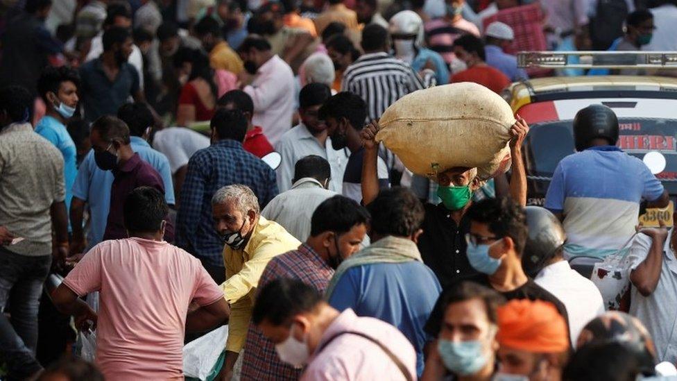 People are seen at a crowded market amidst the spread of the coronavirus disease (COVID-19) in Mumbai, India, October 29, 2020.