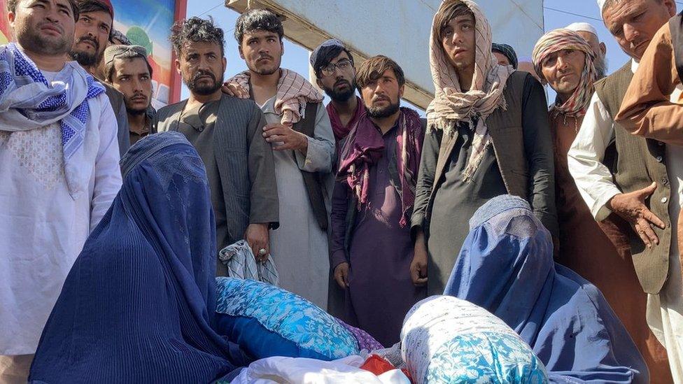 Shagufta at the market in Mazar-i-Sharif. "I am selling my children's finest clothes," she said.