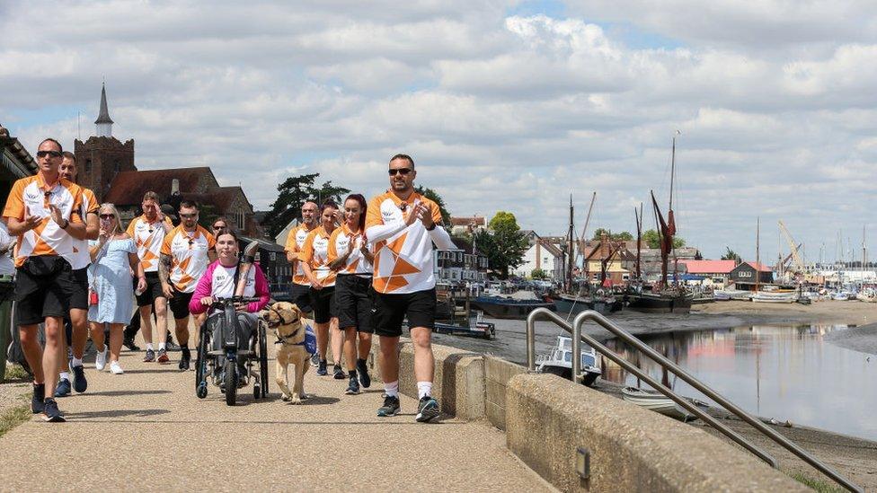 Baton bearer Alex Dowse holds the Queen's Baton during the Birmingham 2022 Queen's Baton Relay on July 08, 2022 in Maldon