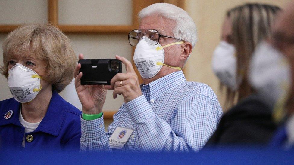 People watch Joe Biden speak in Florida