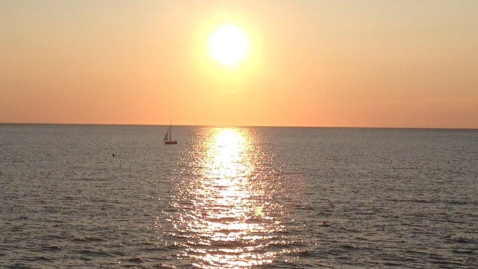 Owain Davies, of Cardiff, took this picture from Gwbert, Ceredigion of a sailing boat as the sun sets over Cardigan Bay