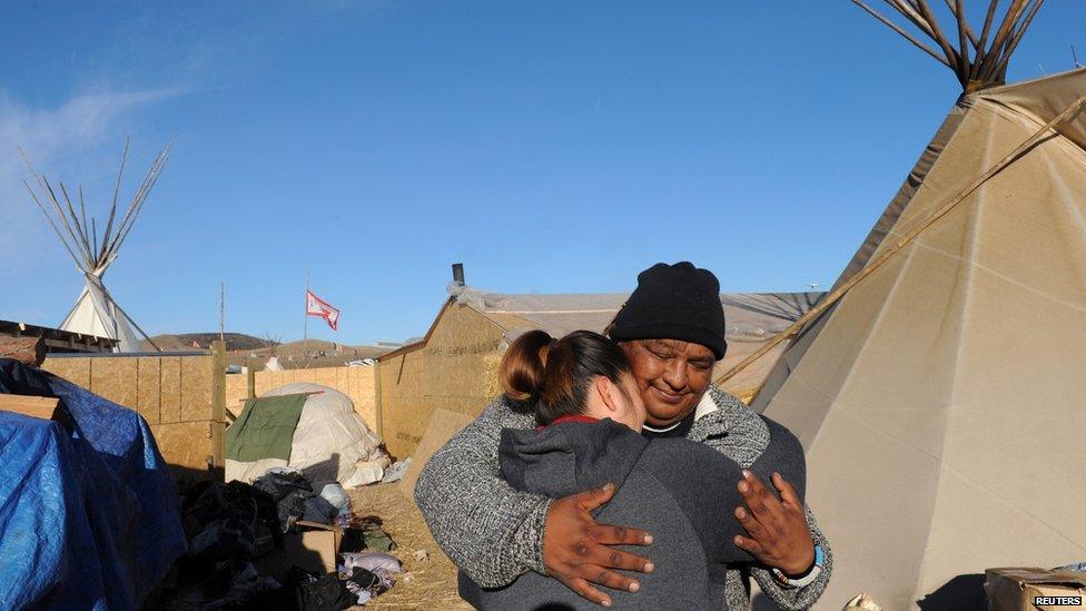 This is a photo of people two native American people on the Sioux reservation site.