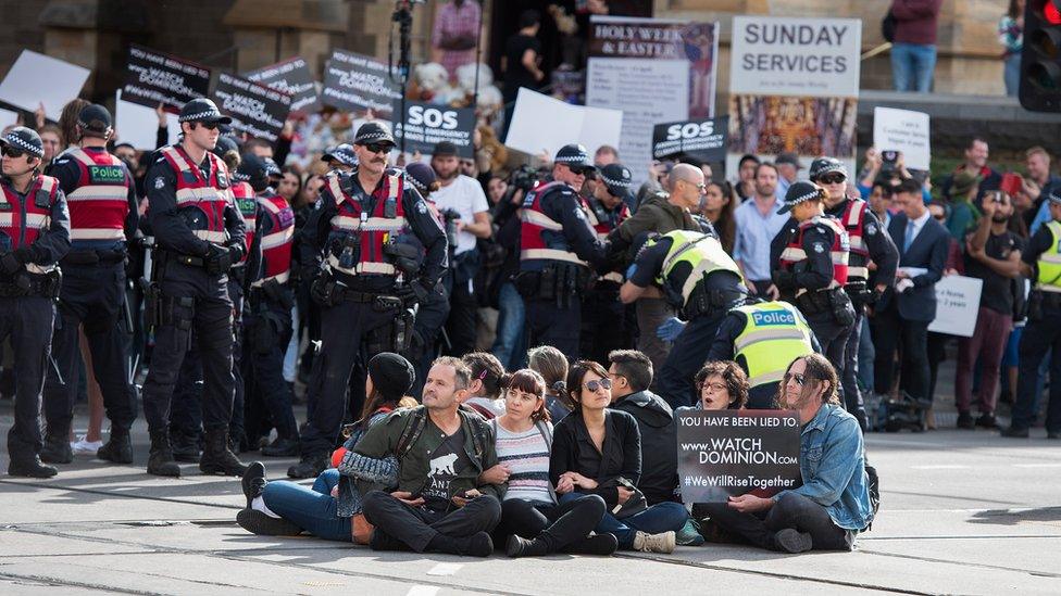 Police move in on animal rights protesters sitting on roads in the middle of Melbourne