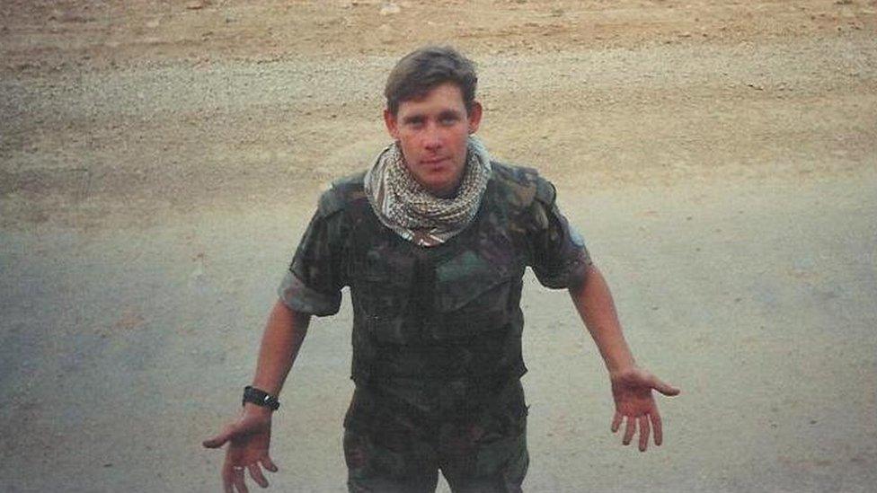 Dr Gareth Thomas in military fatigues in the desert before his injury