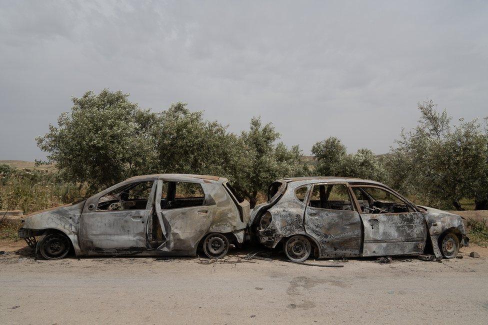 Torched cars in the West Bank village of al-Mughayyir. Settlers burned more than 20 homes and 100 cars during their attacks