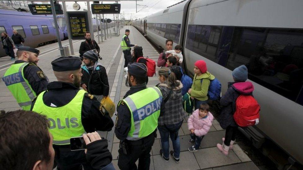 Police gather a group of migrants coming off an incoming train at the Swedish end of the bridge between Sweden and Denmark (photo from 12 November 2015)