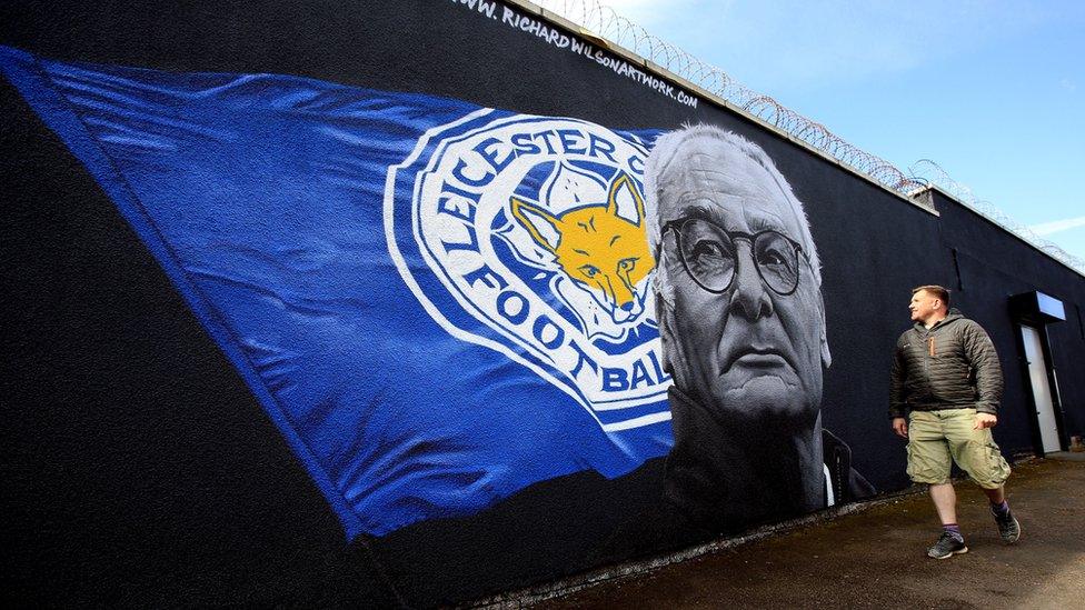 A mural depicting Claudio Ranieri beside a Leicester City flag