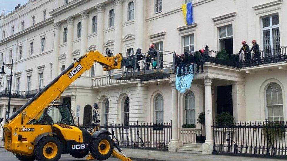 Police used a JCB crane to gain access to the mansion after cordoning off the street