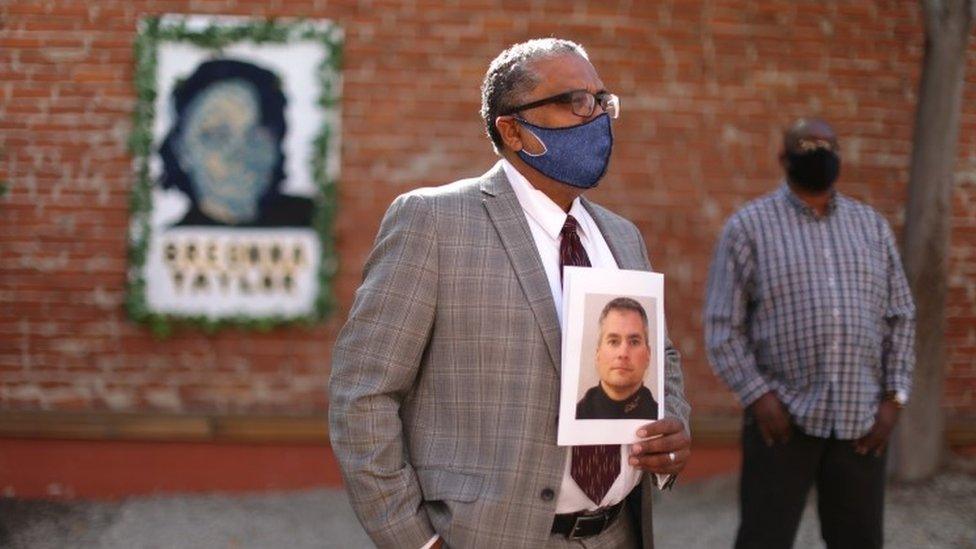 People hold a prayer vigil in memory of Brian Sicknick in Los Angeles