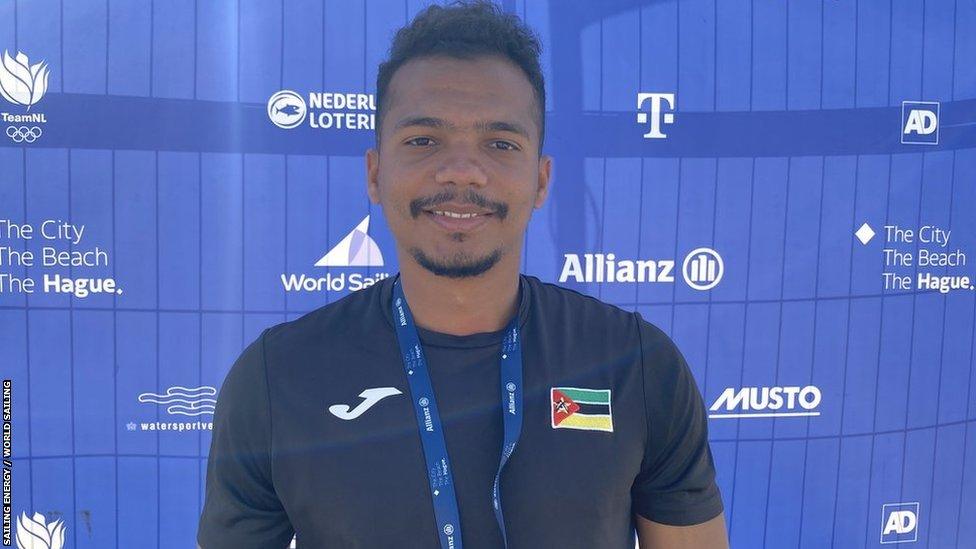 Mozambique sailor Alcido Lino smiles into the camera as he wears t-shirt and lanyard