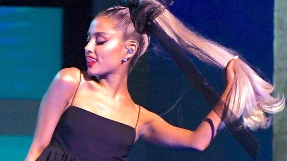 Ariana Grande holding her pony tail