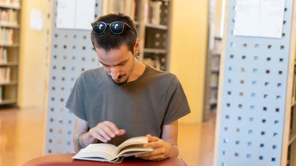 Man reading in library