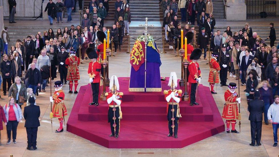 Members of the public file past the coffin of Queen Elizabeth II in Westminster Hall