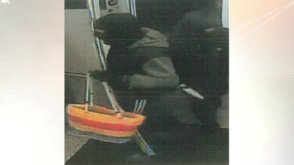 Robber carries shopping bag