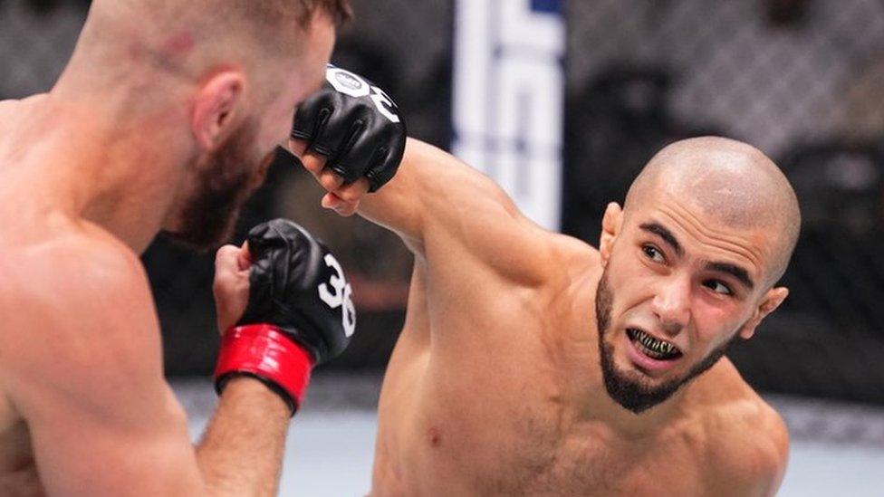 Muhammad Mokaev throwing a punch during his fight withTim Elliott in a bantamweight fight during the UFC 294 event at Etihad Arena on October 21, 2023 in Abu Dhabi, United Arab Emirates