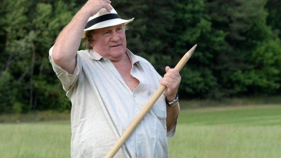 Gerard Depardieu rests during hand-scything