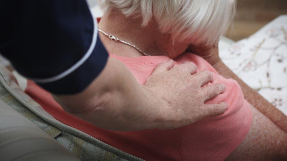 Nurse with her hand on patient's shoulder